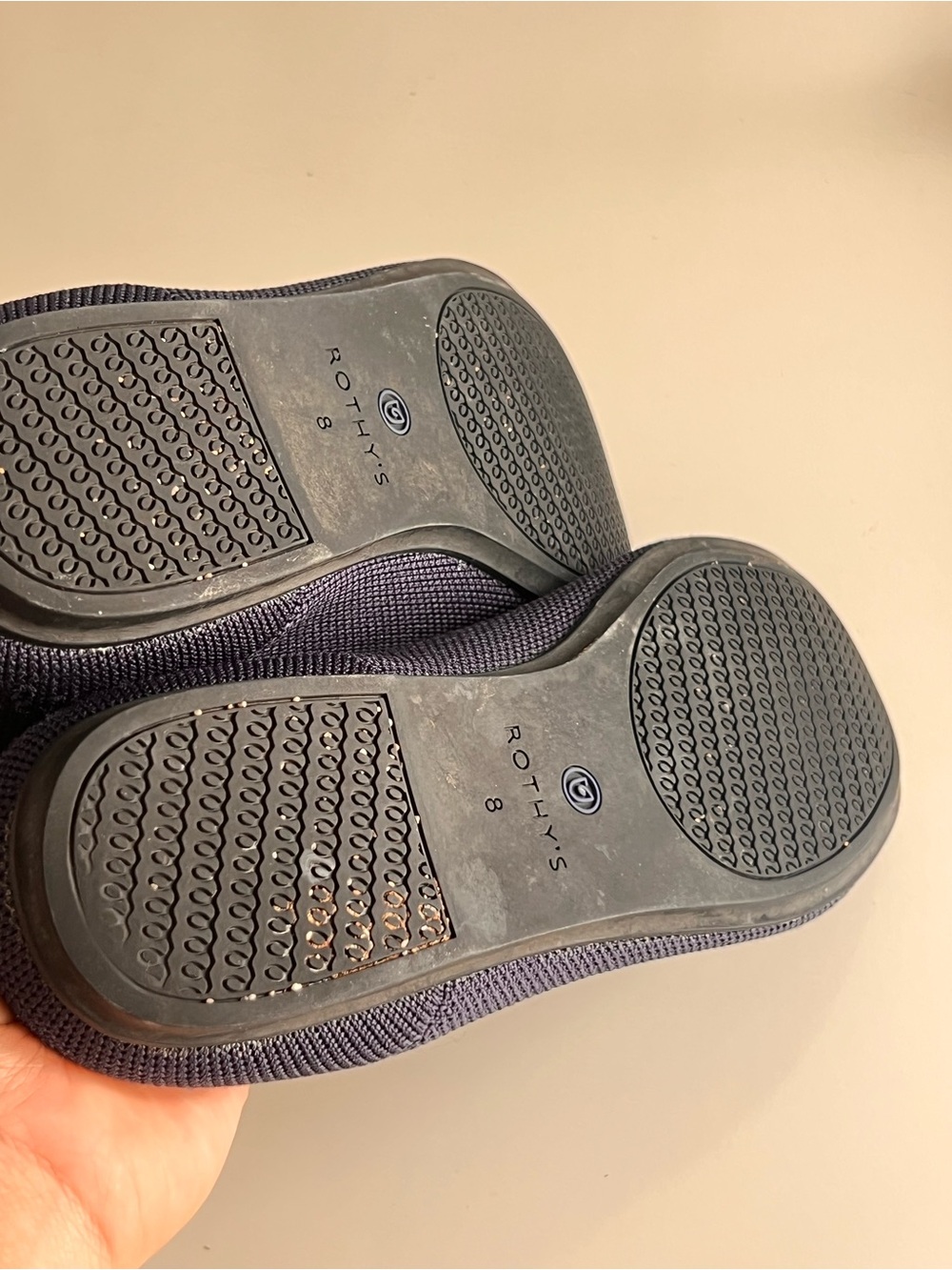 Rothy's navy blue round-toe knit flat shoes featuring a distinctive bright blue - Picture 11 of 12
